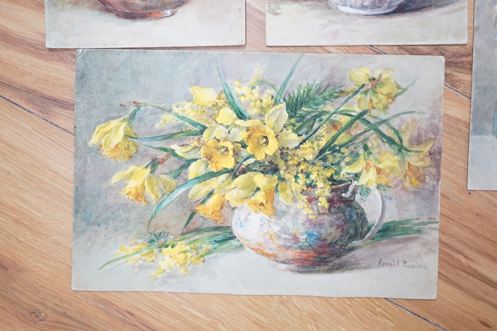 Annie L. Pressland (1862-1933), four watercolours on card, ‘Blue Cranesbill & Musk Mallow’, ‘Daffodils & Mimosa’, Yellow Snapdragons & Cornflowers’ and ‘Narcissi & Auriculas’, one signed, unframed, largest 27 x 17.5cm. C